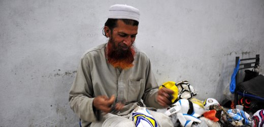 man sewing football